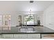 Open kitchen with stainless appliances, granite countertops, and breakfast nook that overlooks the pool area at 647 Saranac Dr, Winter Springs, FL 32708