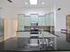 Gourmet kitchen featuring stainless appliances, granite countertops, dual faucet sink, and light green cabinetry at 647 Saranac Dr, Winter Springs, FL 32708