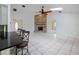 Spacious living room with brick fireplace, high ceilings, tile flooring, and access to the kitchen at 647 Saranac Dr, Winter Springs, FL 32708