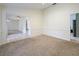 Spacious living room with plush carpeting and large opening to the Gathering room with views to the fireplace at 647 Saranac Dr, Winter Springs, FL 32708