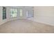 Inviting living room featuring neutral carpet, large windows, and an open layout at 647 Saranac Dr, Winter Springs, FL 32708