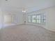 Bright living room with large bay window and new carpeting at 647 Saranac Dr, Winter Springs, FL 32708