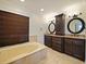 Luxurious main bathroom with a soaking tub, dark wood cabinets, and dual sinks at 647 Saranac Dr, Winter Springs, FL 32708