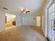 Carpeted main bedroom with ensuite bathroom, ceiling fan, and access to private outdoor entrance at 647 Saranac Dr, Winter Springs, FL 32708