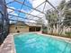 Inviting screened pool with a brick deck, perfect for enjoying the outdoors at 647 Saranac Dr, Winter Springs, FL 32708