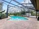 Beautiful screened-in pool with brick patio, perfect for relaxing or swimming at 647 Saranac Dr, Winter Springs, FL 32708