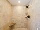 Tiled shower features include a rainfall shower head, a built-in bench, and two corner shelves at 647 Saranac Dr, Winter Springs, FL 32708