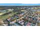 Aerial view of upscale neighborhood with golf course and various houses at 7400 Soiree Way, Reunion, FL 34747