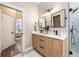 Double vanity bathroom with modern fixtures and a large mirror at 7400 Soiree Way, Reunion, FL 34747