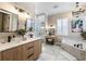 Elegant bathroom with a soaking tub and double vanity at 7400 Soiree Way, Reunion, FL 34747