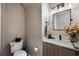 Stylish powder room with modern vanity, quartz countertop and black accents at 7400 Soiree Way, Reunion, FL 34747