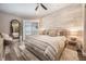 Spacious primary bedroom with wood-like floors and stylish decor at 7400 Soiree Way, Reunion, FL 34747