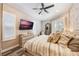Main bedroom with king-size bed, wood-look flooring and large windows at 7400 Soiree Way, Reunion, FL 34747