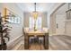 Elegant dining room with a modern wood table and statement chandelier at 7400 Soiree Way, Reunion, FL 34747
