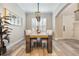 Spacious dining area showcasing a large wooden table and stylish chandelier at 7400 Soiree Way, Reunion, FL 34747
