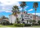 Two-story house with a front porch and landscaping at 7400 Soiree Way, Reunion, FL 34747
