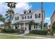 Two-story house with a front porch and landscaping at 7400 Soiree Way, Reunion, FL 34747