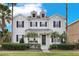 Two-story house with a front porch and landscaping at 7400 Soiree Way, Reunion, FL 34747