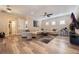 Bright Gathering room with L-shaped sectional and hardwood floors at 7400 Soiree Way, Reunion, FL 34747