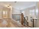 Elegant hallway with hardwood floors and modern railing at 7400 Soiree Way, Reunion, FL 34747