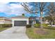 Single-story home with attached garage and lush landscaping at 7400 Soiree Way, Reunion, FL 34747