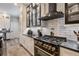 Luxurious kitchen with black and gold accents, gas range, and custom cabinetry at 7400 Soiree Way, Reunion, FL 34747