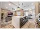Modern kitchen with marble island, stainless steel appliances, and white shaker cabinets at 7400 Soiree Way, Reunion, FL 34747