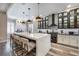 Modern kitchen with white cabinets, quartz island, and high-end appliances at 7400 Soiree Way, Reunion, FL 34747