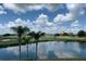 Peaceful lake view with golf course and building in the background at 7400 Soiree Way, Reunion, FL 34747