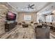 Living area boasts a stone fireplace, large TV, and ample seating at 7400 Soiree Way, Reunion, FL 34747