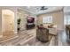 Comfortable living room with sectional sofa, stone accent wall, and hardwood floors at 7400 Soiree Way, Reunion, FL 34747