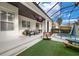 Screened pool and patio area with lounge chairs and summer kitchen at 7400 Soiree Way, Reunion, FL 34747