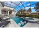 Enclosed pool and spa with grilling station and lounge chairs at 7400 Soiree Way, Reunion, FL 34747