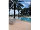 Inviting community pool with lounge chairs and tables at 7400 Soiree Way, Reunion, FL 34747