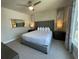 Serene bedroom with king-size bed and large windows at 7740 Sandy Ridge Dr # 205, Reunion, FL 34747