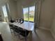 Bright dining area with modern table and chairs and window views at 7740 Sandy Ridge Dr # 205, Reunion, FL 34747