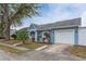 Ranch style home with a white garage door and palm trees at 8465 Oak Bluff Dr, Orlando, FL 32827