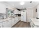 Modern white kitchen with stainless steel appliances and tile backsplash at 8465 Oak Bluff Dr, Orlando, FL 32827