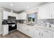 Updated kitchen with white cabinets and quartz countertops at 8465 Oak Bluff Dr, Orlando, FL 32827