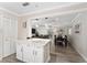 White kitchen with an island and a view into the living area at 8465 Oak Bluff Dr, Orlando, FL 32827