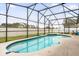 Relaxing kidney-shaped pool with screened enclosure at 2615 Cobalt Ct, Orlando, FL 32837