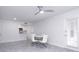 Dining area with glass table and white chairs, view of kitchen at 11508 Westwood Blvd # 313, Orlando, FL 32821