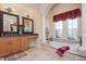 Spa-like bathroom with soaking tub and dual vanities at 13412 Heswall Run, Orlando, FL 32832