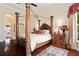 Elegant Primary bedroom with large four-poster bed and hardwood floors at 13412 Heswall Run, Orlando, FL 32832