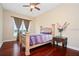 Bright bedroom with hardwood floors and a large window at 13412 Heswall Run, Orlando, FL 32832