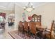 Elegant dining room with a large table, and views into the kitchen at 13412 Heswall Run, Orlando, FL 32832