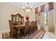 Formal dining room with a large table, beautiful chandelier, and hardwood floors at 13412 Heswall Run, Orlando, FL 32832