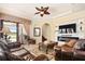 Spacious living room with fireplace, large TV, and comfortable seating at 13412 Heswall Run, Orlando, FL 32832