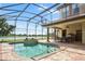 Spacious pool and patio area with outdoor kitchen and lake view at 13412 Heswall Run, Orlando, FL 32832
