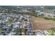 Aerial view of neighborhood with houses, roads, and a large empty lot at 1511 Oak Hill Trl, Kissimmee, FL 34747